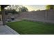 Backyard featuring a patio, grass, and block wall providing privacy at 16046 W Hearn Rd, Surprise, AZ 85379
