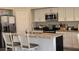 Modern kitchen features white cabinets, granite countertops, and stainless steel appliances at 16046 W Hearn Rd, Surprise, AZ 85379