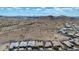 Expansive aerial view of desert landscape with luxury homes and mountain views on a bright sunny day in Estrella at 16389 W Fawn Dr, Goodyear, AZ 85338