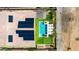 Aerial view of a backyard with a pool, putting green, solar panels and desert landscape at 16389 W Fawn Dr, Goodyear, AZ 85338