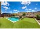 Stunning backyard features include a pool, outdoor kitchen, putting green, desert landscaping, and mountain views at 16389 W Fawn Dr, Goodyear, AZ 85338