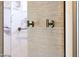 Bathroom wall details with hooks and shower out of focus in background at 16389 W Fawn Dr, Goodyear, AZ 85338