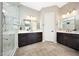 Elegant bathroom with dual vanities, sleek fixtures, and a glass-enclosed shower at 16389 W Fawn Dr, Goodyear, AZ 85338