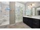 Bathroom showcasing dual-vanity design and marble shower at 16389 W Fawn Dr, Goodyear, AZ 85338