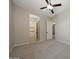 This bedroom features neutral colors, ceiling fan and an ensuite bathroom at 16389 W Fawn Dr, Goodyear, AZ 85338