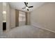 Bright, airy bedroom with a ceiling fan, neutral walls, and soft carpeting at 16389 W Fawn Dr, Goodyear, AZ 85338