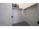 Walk-in closet featuring built-in shelving and wooden rod for optimal storage at 16389 W Fawn Dr, Goodyear, AZ 85338
