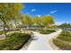 Neighborhood park featuring a walking path, lush green landscaping, and covered ramada at 16389 W Fawn Dr, Goodyear, AZ 85338
