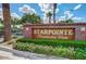 Elegant brick sign for Starpointe Residents Club surrounded by flowers and greenery, marking a welcoming community entrance at 16389 W Fawn Dr, Goodyear, AZ 85338