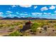 Scenic view of the Estrella community with desert landscape, mountain backdrop, and unique architecture at 16389 W Fawn Dr, Goodyear, AZ 85338