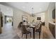 Elegant dining room showcasing a table set for six, stylish chandelier, and contemporary décor at 16389 W Fawn Dr, Goodyear, AZ 85338