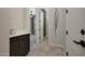 Hallway with views of the bedroom and bathroom, featuring tile flooring and neutral paint at 16389 W Fawn Dr, Goodyear, AZ 85338