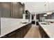 Contemporary kitchen with white countertops, dark cabinets, and stainless steel appliances at 16389 W Fawn Dr, Goodyear, AZ 85338