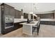Modern kitchen featuring stainless steel appliances, a large island, and sleek, dark wood cabinetry at 16389 W Fawn Dr, Goodyear, AZ 85338