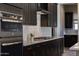 Modern kitchen with stainless steel oven and gas cooktop, contrasted by dark cabinets and white countertops at 16389 W Fawn Dr, Goodyear, AZ 85338