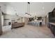 Expansive living area featuring a stylish kitchen, comfortable seating, and modern lighting fixtures at 16389 W Fawn Dr, Goodyear, AZ 85338