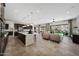 Open-concept living space featuring a modern kitchen, comfortable seating, and sliding glass doors to a backyard pool at 16389 W Fawn Dr, Goodyear, AZ 85338