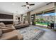Comfortable living room with a ceiling fan, backyard views, and contemporary furnishings at 16389 W Fawn Dr, Goodyear, AZ 85338