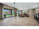 Spacious living area with large windows, sleek tile flooring, and views of the pool and landscape at 16389 W Fawn Dr, Goodyear, AZ 85338