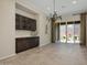 Open floorplan with tiled floors, decorative chandelier, built-in storage, and sliding glass doors at 16389 W Fawn Dr, Goodyear, AZ 85338