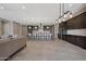 Open-concept living space with a modern kitchen, comfortable seating, and seamless flow throughout at 16389 W Fawn Dr, Goodyear, AZ 85338
