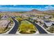 Aerial view of a well-planned neighborhood with lush landscaping and mountain views at 16389 W Fawn Dr, Goodyear, AZ 85338