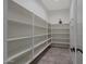 Spacious walk-in pantry with ample shelving for storage and organization at 16389 W Fawn Dr, Goodyear, AZ 85338