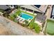 Aerial view of a stunning backyard with a pool, lounge seating, and lush landscaping at 16389 W Fawn Dr, Goodyear, AZ 85338