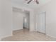 Neutral bedroom featuring tile flooring, a ceiling fan, neutral paint, and closet with white doors at 17376 W Via De Luna Dr, Surprise, AZ 85387