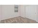 This bedroom features neutral carpet, a window, and a closet with sliding doors at 17376 W Via De Luna Dr, Surprise, AZ 85387