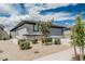 Single-Gathering home features desert landscaping, gray exterior, and a private two-car garage at 17376 W Via De Luna Dr, Surprise, AZ 85387