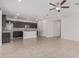 Open-concept kitchen with stainless steel appliances and kitchen island overlooking living area at 17376 W Via De Luna Dr, Surprise, AZ 85387