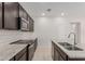 Modern kitchen with granite countertops, stainless appliances, and sleek cabinetry at 17376 W Via De Luna Dr, Surprise, AZ 85387