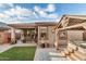 Inviting backyard with covered patio, outdoor decor, and views of the well-maintained landscaping at 17419 W Georgia Dr, Surprise, AZ 85388