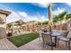 Backyard features a covered hot tub, patio, landscaped yard, and outdoor dining area at 17419 W Georgia Dr, Surprise, AZ 85388