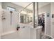 Bathroom showcasing the walk-in glass shower, shelving, and a walk-in closet at 17419 W Georgia Dr, Surprise, AZ 85388