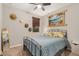 The bedroom features a ceiling fan, neutral colored walls, and an iron bed frame at 17419 W Georgia Dr, Surprise, AZ 85388