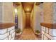 Charming entryway with textured walls, decorative iron door, and potted plants at 17419 W Georgia Dr, Surprise, AZ 85388