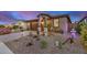 Inviting exterior of desert home with xeriscaping, charming porch, and two-car garage at 17419 W Georgia Dr, Surprise, AZ 85388