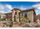 Beautiful exterior featuring a landscaped front yard, cozy porch, and desert-themed decor at 17419 W Georgia Dr, Surprise, AZ 85388