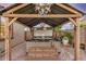 A covered hot tub with wooden steps for easy access, set in a stylish outdoor space at 17419 W Georgia Dr, Surprise, AZ 85388