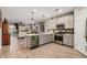 Modern kitchen featuring stainless steel appliances, white cabinets, quartz countertops, and an open layout at 17419 W Georgia Dr, Surprise, AZ 85388