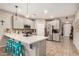 Bright kitchen with stainless steel appliances, a quartz countertop island, and seamless access to the entryway at 17419 W Georgia Dr, Surprise, AZ 85388
