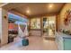 Relaxing covered patio with a hanging chair and slider entry to the main living space at 17419 W Georgia Dr, Surprise, AZ 85388
