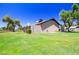 Expansive backyard featuring lush lawn, mature trees, and privacy fencing at 17802 N 45Th Ave, Glendale, AZ 85308