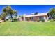 Large backyard with green grass, mature trees, a fence and a cozy patio area at 17802 N 45Th Ave, Glendale, AZ 85308