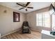 Bedroom featuring hardwood floors, a chair, a window with blinds, and neutral walls at 17802 N 45Th Ave, Glendale, AZ 85308