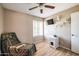Bedroom featuring hardwood floors, a chair, a window with blinds, and neutral walls at 17802 N 45Th Ave, Glendale, AZ 85308