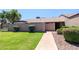 Well-maintained front yard with lush green grass and mature landscaping at 17802 N 45Th Ave, Glendale, AZ 85308