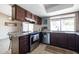 Well-lit kitchen featuring stainless steel appliances, tile flooring, and granite countertops at 17802 N 45Th Ave, Glendale, AZ 85308